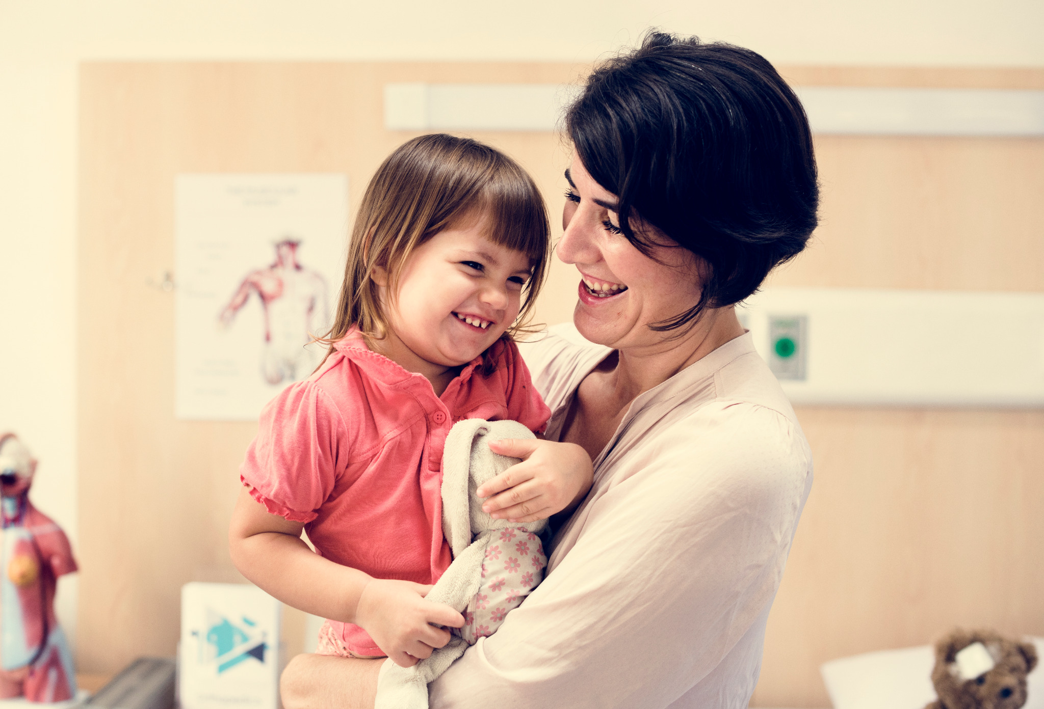 Care professional supporting a child in a clinical setting