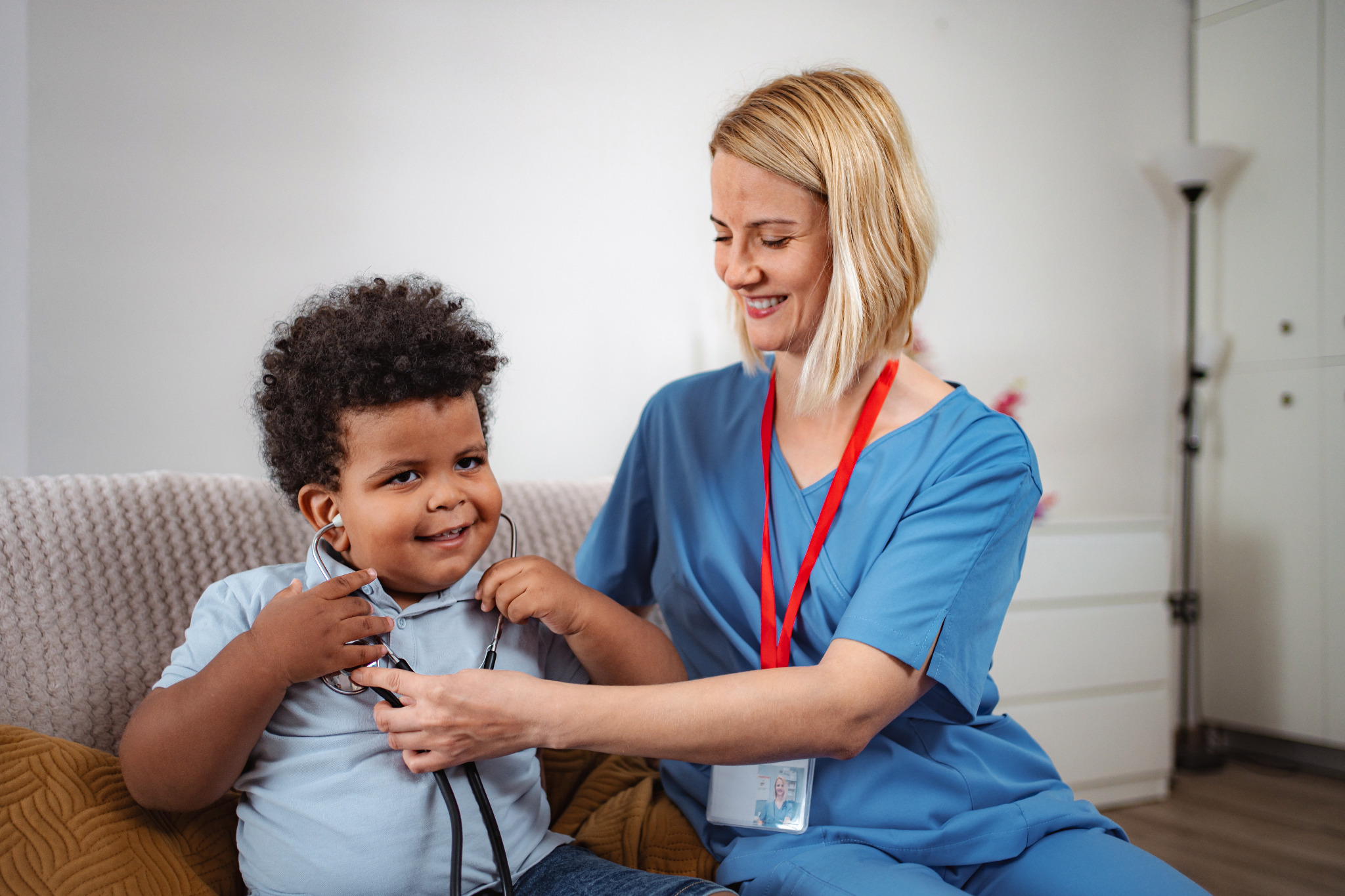 Child and care professional sharing a playful healthcare activity